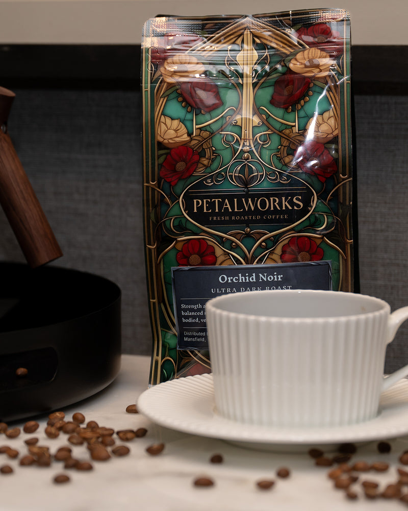 Orchid Noir ultra-dark roast coffee with a cup and coffee beans