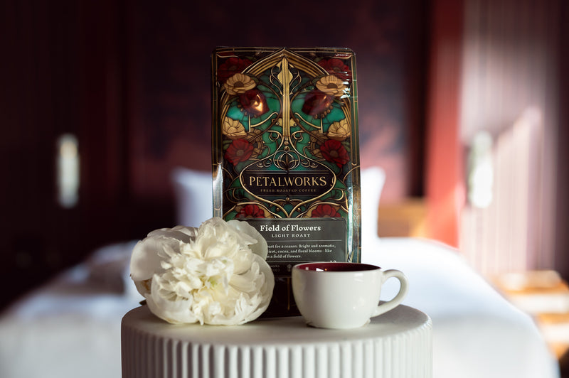 Field of Flowers light roast coffee, styled with a white peony and cup